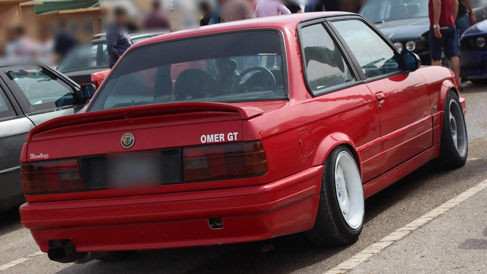 Source photo, 2015: the same car at a daytime car meet in Iraq, faces and plate blurred