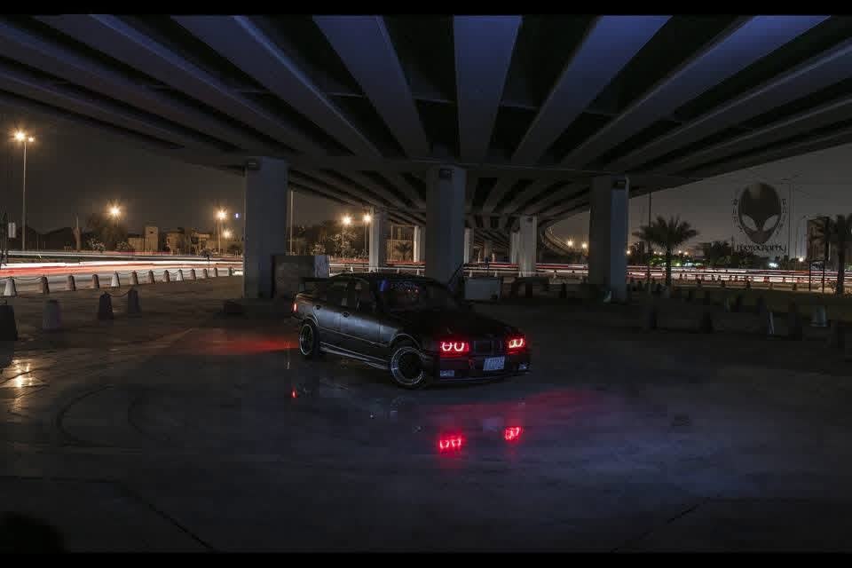 BMW E36 convertible under a flyover, lit with continuous sources